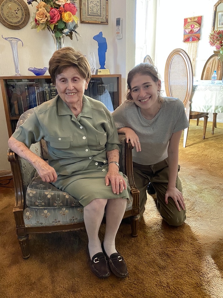 Bronia and Tillie smiling together in Bronia's living room.