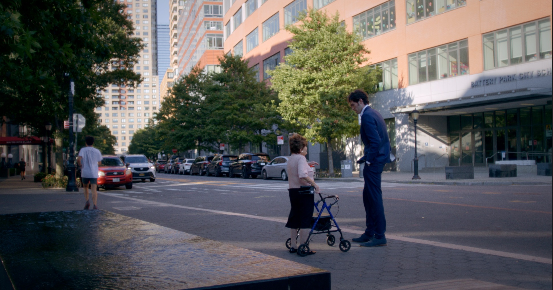 Bronia with her walker and Isaac talking on a street corner in Battery Park City.